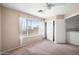 Bright bedroom featuring natural light, carpet floors, a ceiling fan, and a closet with white doors at 665 S Balboa --, Mesa, AZ 85206