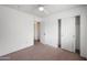 This bedroom features neutral carpet, a ceiling fan, and a closet with white doors at 665 S Balboa --, Mesa, AZ 85206