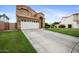 Charming two-story home with a well-maintained lawn and long driveway at 665 S Balboa --, Mesa, AZ 85206