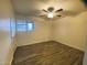 Bedroom with wood-look flooring, ceiling fan, and window at 6729 N 16Th St # 21, Phoenix, AZ 85016
