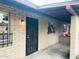 Home exterior featuring a secure iron gate, brick accents, and a cozy, covered patio area at 6729 N 16Th St # 21, Phoenix, AZ 85016