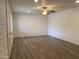 Bright living room with ceiling fan, wood-look floors, and decorative wainscoting at 6729 N 16Th St # 21, Phoenix, AZ 85016