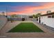The backyard features gravel, artificial turf, and simple desert landscaping for a minimalist aesthetic at 7026 E Pasadena Ave, Paradise Valley, AZ 85253