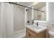 The cozy bathroom features a bathtub, shower, and a vanity with a bright framed mirror at 7026 E Pasadena Ave, Paradise Valley, AZ 85253