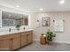 Bathroom features a wood vanity with double sinks, quartz countertop, and framed mirror at 7026 E Pasadena Ave, Paradise Valley, AZ 85253