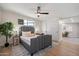 This bedroom features a gray upholstered bed, a ceiling fan and a window for natural light at 7026 E Pasadena Ave, Paradise Valley, AZ 85253