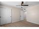 Sunlit bedroom with ceiling fan, wood floors, and ample closet space for optimal storage at 7026 E Pasadena Ave, Paradise Valley, AZ 85253