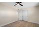 Light-filled bedroom features a ceiling fan, wood floors, and closet for ample storage at 7026 E Pasadena Ave, Paradise Valley, AZ 85253