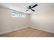 Bright bedroom with sleek wood floors, a contemporary ceiling fan, and sunlit window at 7026 E Pasadena Ave, Paradise Valley, AZ 85253