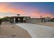 Beautiful mid-century modern home featuring a long driveway, carport, and desert-style landscaping at 7026 E Pasadena Ave, Paradise Valley, AZ 85253
