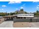 Mid-century modern home with a carport, block wall, desert landscaping, and mountain views at 7026 E Pasadena Ave, Paradise Valley, AZ 85253