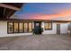 Charming home exterior with a modern black front door, decorative plants, and updated windows at 7026 E Pasadena Ave, Paradise Valley, AZ 85253