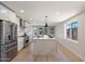 Bright kitchen featuring stainless steel appliances, white cabinets, and a large quartz island at 7026 E Pasadena Ave, Paradise Valley, AZ 85253