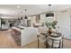 Bright kitchen featuring a large island with seating, stainless steel appliances, and an adjacent dining area at 7026 E Pasadena Ave, Paradise Valley, AZ 85253