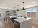Open-concept kitchen featuring an island with seating, stainless steel sink, and modern appliances at 7026 E Pasadena Ave, Paradise Valley, AZ 85253