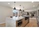 Spacious kitchen island with seating, stainless steel sink, and modern appliances open to a living area at 7026 E Pasadena Ave, Paradise Valley, AZ 85253