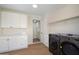Laundry room featuring modern washer/dryer units, sleek cabinetry, and ample storage space at 7026 E Pasadena Ave, Paradise Valley, AZ 85253