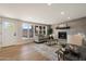 Bright living room with hardwood floors, a modern fireplace, and an open layout to the entry door at 7026 E Pasadena Ave, Paradise Valley, AZ 85253