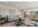 Open-concept living room featuring hardwood floors, neutral paint, and seamless kitchen access at 7026 E Pasadena Ave, Paradise Valley, AZ 85253