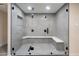 A modern walk-in shower offers a sleek design with glass enclosure and a built-in bench at 7026 E Pasadena Ave, Paradise Valley, AZ 85253