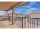 A balcony features iron railings and views of neighboring homes on a sunny day at 820 E Agua Fria Ln, Avondale, AZ 85323