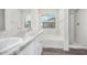 Bright bathroom featuring double sinks, a soaking tub, and a glass-enclosed shower at 820 E Agua Fria Ln, Avondale, AZ 85323
