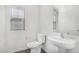 Powder bath with white sink, toilet and window at 820 E Agua Fria Ln, Avondale, AZ 85323
