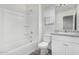 Bright, white bathroom featuring a tub, toilet, vanity, and wood-look floors at 820 E Agua Fria Ln, Avondale, AZ 85323
