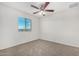 Bedroom with a ceiling fan, neutral walls, carpeted floor, and a window at 820 E Agua Fria Ln, Avondale, AZ 85323