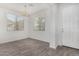 Dining room with two windows and modern light fixture at 820 E Agua Fria Ln, Avondale, AZ 85323
