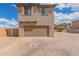 Exterior elevation view of a home with a two-car garage and desert landscaping at 820 E Agua Fria Ln, Avondale, AZ 85323