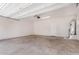 Spacious garage with neutral walls, concrete floor, and overhead lighting and garage door hardware at 820 E Agua Fria Ln, Avondale, AZ 85323