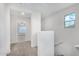 Upstairs hallway features neutral carpet, white walls and natural lighting at 820 E Agua Fria Ln, Avondale, AZ 85323