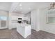 Bright kitchen features white cabinets, stainless steel appliances, and a convenient center island at 820 E Agua Fria Ln, Avondale, AZ 85323