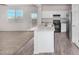 Kitchen with white cabinets, stainless steel appliances, stone countertops, and wood-look floors at 820 E Agua Fria Ln, Avondale, AZ 85323