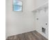Laundry room featuring wood-look floors, utility connections, and a window at 820 E Agua Fria Ln, Avondale, AZ 85323