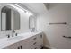 Modern bathroom featuring dual sinks, elegant mirrors, and sleek black fixtures at 8309 E Rose Ln, Scottsdale, AZ 85250