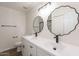 Stylish bathroom features dual sinks, modern vanity, and decorative mirrors at 8309 E Rose Ln, Scottsdale, AZ 85250