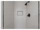 Sleek shower with minimalist black fixtures and modern white tile work at 8309 E Rose Ln, Scottsdale, AZ 85250