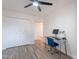 Versatile bedroom with wood-look flooring, a work station, and ample closet space at 8309 E Rose Ln, Scottsdale, AZ 85250