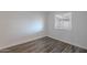 Well-lit bedroom with wood-look floors and a window, offering a versatile space at 8309 E Rose Ln, Scottsdale, AZ 85250