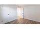 Bright bedroom showcasing wood-look tile floors and fresh, white walls at 8309 E Rose Ln, Scottsdale, AZ 85250