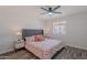 Bedroom featuring a ceiling fan, window, and a well-decorated bed with bedside tables at 8309 E Rose Ln, Scottsdale, AZ 85250