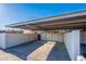 View of the community carport with covered parking and privacy walls at 8309 E Rose Ln, Scottsdale, AZ 85250