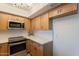 Contemporary kitchen with stainless steel appliances, modern countertops, and plenty of cabinet storage at 8309 E Rose Ln, Scottsdale, AZ 85250