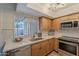 Modern kitchen equipped with stainless steel appliances, sleek countertops, and a bright, airy atmosphere at 8309 E Rose Ln, Scottsdale, AZ 85250