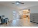 Bright living room features tile floors, ceiling fan, and a sliding glass door to patio at 8309 E Rose Ln, Scottsdale, AZ 85250