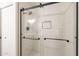 Modern shower features sleek glass doors, black hardware, and tiled walls at 8309 E Rose Ln, Scottsdale, AZ 85250
