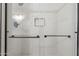 Sleek glass-enclosed shower with a niche, complemented by modern fixtures and tile work at 8309 E Rose Ln, Scottsdale, AZ 85250