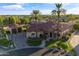 Aerial shot of a beautiful home, showcasing its lush landscaping, red tile roof, and neighborhood at 8325 W Cantera Ave, Peoria, AZ 85383